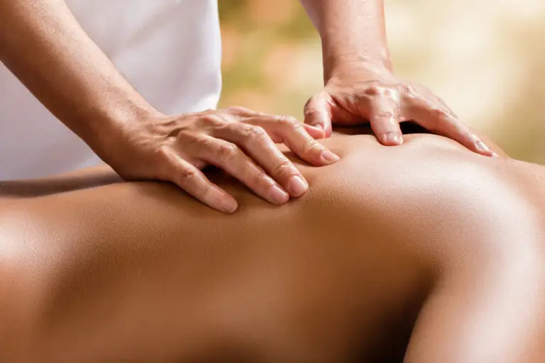 Close-up of hands giving a back massage. Relaxing spa treatment.
