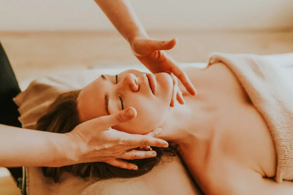 Relaxing woman receiving a facial massage