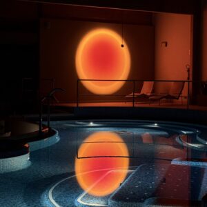 Indoor spa pool with a sunset-like light reflection, creating a relaxing atmosphere.